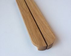 a close up of a wooden object on a white surface with no one around it