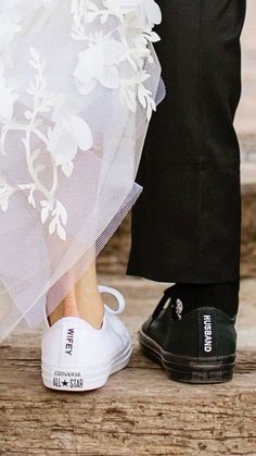 a bride and groom's feet in wedding shoes, with the veil pulled back