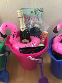 two buckets filled with various items on top of a wooden table