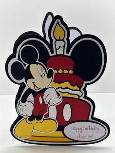 a mickey mouse birthday card with a candle in the shape of a cake on top