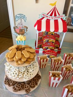 a table topped with cookies and pretzels next to cupcakes on top of each other