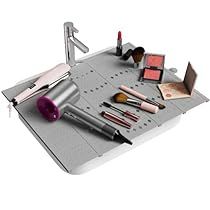 an assortment of makeup and eyeliners on a metal tray with a faucet