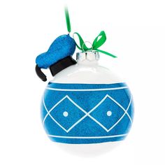 a blue and white ornament hanging from a green ribbon on a white background