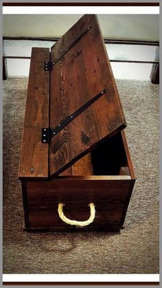 an open wooden box sitting on top of a carpeted floor next to a wall