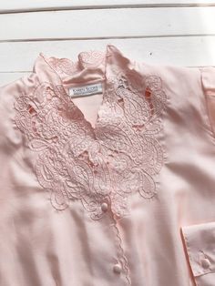 A silky pastel pink blouse, with very detailed cutwork lace and embroidery on the collar and neckline. ☛ m e a s u r e m e n t s ☚ Best for: M Bust: 40 Waist: 34 Shoulders: 15 Length: 25 ☛ d e t a i l s ☚ Era: 1980s Material: polyester Condition: excellent Pink Feminine Embroidered Blouse, Pink Embroidered Feminine Blouse, Summer Pink Tops With Lace Collar, Pink Lace Collar Tops For Summer, Pink Tops With Lace Collar For Summer, Pink Tops With Lace Collar For Daywear, Pink Floral Embroidered Blouse For Daywear, Pink Blouse With Lace Collar For Daywear, Pink Embroidered Collared Top