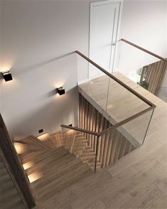 an overhead view of a staircase with wooden handrails and glass balconies