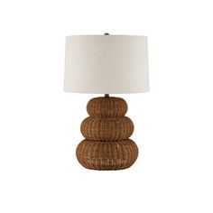 a lamp that is sitting on top of a wooden base with a white lampshade