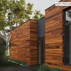 the exterior of a modern home with wood siding and glass windows, along with trees in the background