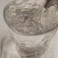 water is being poured into a glass bowl