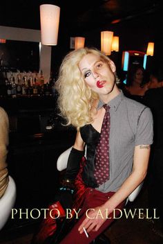 a woman dressed as marilyn monroe sitting in a chair