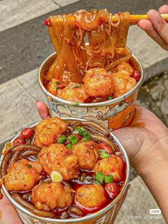 two buckets filled with food sitting on top of a street side walk next to each other