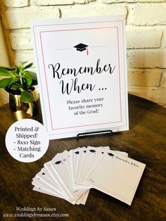 a table topped with lots of cards next to a potted plant