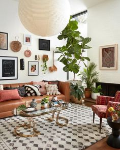 a living room filled with lots of furniture and pictures on the wall above it's coffee table