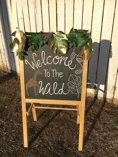 a welcome to the wild sign in front of a fence