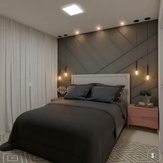 a large bed in a bedroom next to a wall with lights on the headboard