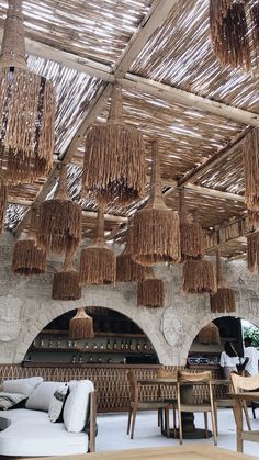 an outdoor restaurant with wicker hanging from the ceiling