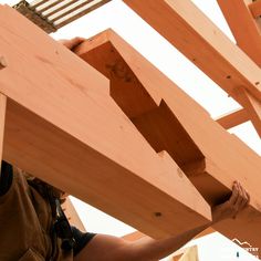 a man is working on some wooden structures