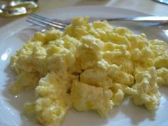 scrambled eggs on a plate with a fork