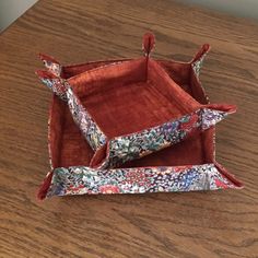 two red trays sitting on top of a wooden table