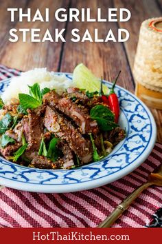 a plate full of meat and vegetables with the words thai grilled steak on it