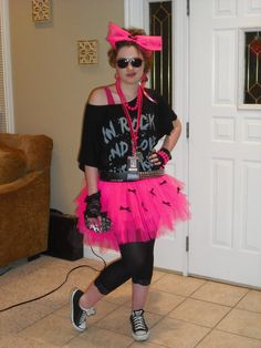 a woman dressed in pink and black posing for the camera