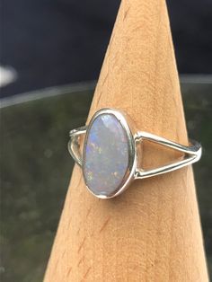 Handmade Australian solid crystal opal ring set in 925 solid silver. Lovely pastel purples and pinks with green and gold flecks. UK Size J  / US size 4.5 / EU size 49  This opal was mined in White Cliffs, NSW, Australia. An Australian crystal opal, hand-made into a ring which will arrive in a gift box with FREE UK delivery. Dispatched within 24 hours  As an opal miner and cutter, I can keep the costs down so that you can enjoy quality Australian opal at really affordable prices.  I have many ite Oval Opal Rings With Polished Finish, Silver Pink Opal Ring Gift, Silver Pink Opal Ring For Gift, Sterling Silver Oval Opal Cabochon Ring, Iridescent Opal Ring As Gift, Oval Cabochon Opal Ring In Sterling Silver, Iridescent Opal Ring For Gift, Sterling Silver Oval Cabochon Opal Ring, Silver Opal Ring Gift