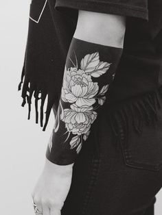 a woman with a flower tattoo on her arm