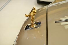 the door handle on an old car with a gold astronaut figure painted on it's side