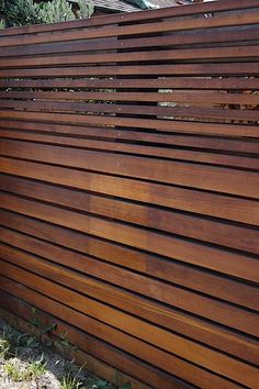 a wooden fence with vertical slats on it