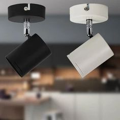 two black and white lights hanging from the ceiling