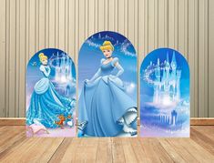 three disney princesses are standing in front of each other on a wooden floor,