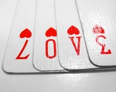 four playing cards with the word love printed on them