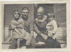 an old black and white photo of a family sitting on a porch with their child