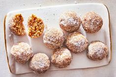 a white plate topped with powdered sugar covered donuts