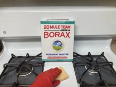 a box of borax sitting on top of a stove next to a glove