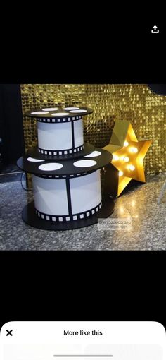 a camera sitting on top of a table next to a star shaped light up sign