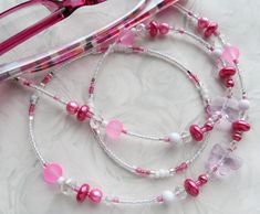 CJ's Inspirations "Pink Butterflies" This charming eyeglass lanyard was made with a collection of crystal butterfly beads, Lucite beads, glass pearls, and sparkling multifaceted crystals.  It makes a wonderful addition to your lanyard collection or a great gift for others. Features and Options: To ensure durability and long-lasting wear, this lanyard has very strong wiring, triple crimping beads, and split jump rings.  Measurement: 29 inches end to end including the eyeglass loops -------------- Pink Glass Beaded Necklaces For Gift, Handmade Pink Glass Beaded Necklaces, Pink Glass Beaded Necklace For Gift, Handmade Adjustable Pink Glasses Chains, Adjustable Pink Glasses Chains As Gift, Handmade Pink Glasses Chains For Summer, Pink Glass Glasses Chains For Summer, Pink Glasses Chains For Summer Beach, Pink Glasses Chains For Beach And Summer