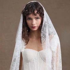 a woman wearing a wedding veil and dress