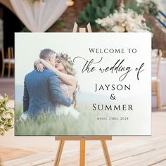 a welcome sign for the newlywed couple to arrive at their wedding reception in front of an outdoor ceremony venue