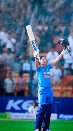 a female cricket player holding her bat up in the air