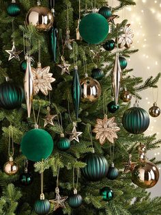 a christmas tree decorated with green and gold ornaments