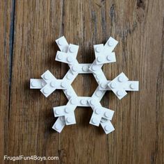 a snowflake made out of legos sitting on top of a wooden table