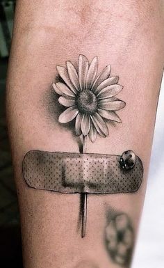 a tattoo with a flower on it and a knife in front of the sunflower