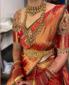 a woman in a red and gold sari