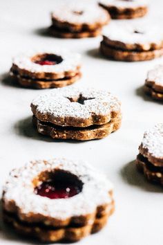 several cookies with powdered sugar and jelly on them