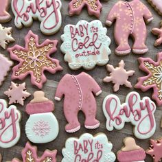 baby its cold outside decorated cookies on a wooden table with pink and white frosting