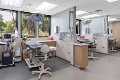 an operating room with medical equipment and large windows in the back drop off area for people to see