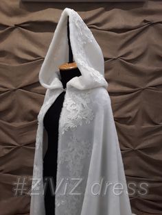 a white shawl draped over a black dress