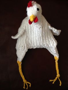 a white knitted chicken hat with yellow legs