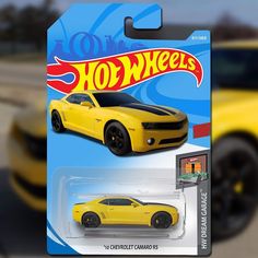 the yellow car is on display in front of a blurry background and it appears to be from hot wheels